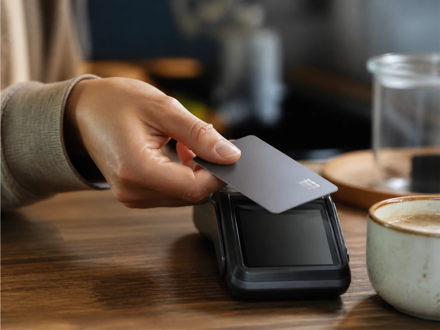A customer tapping a card at the counter