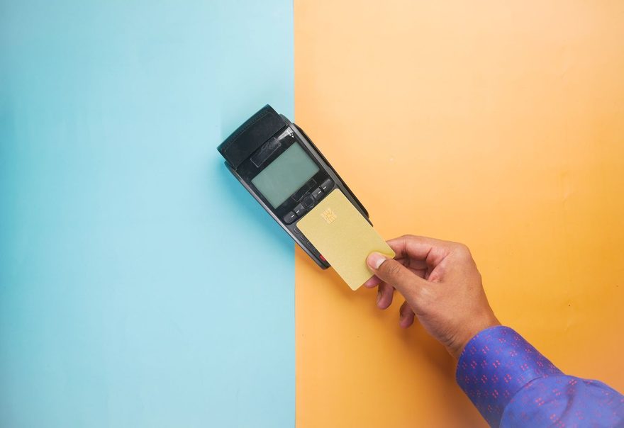 A customer tapping a card against a payment terminal