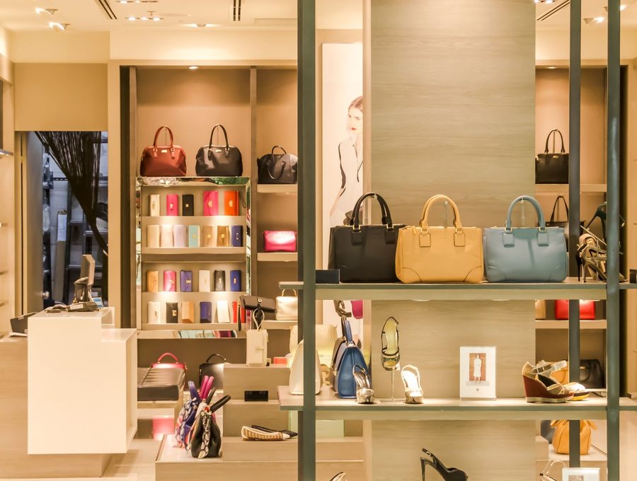 Handbags and shoes arranged on shelves in a boutique