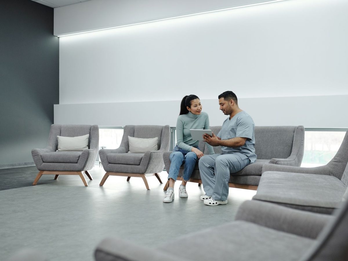 A clinician and patient reviewing a treatment plan on a tablet